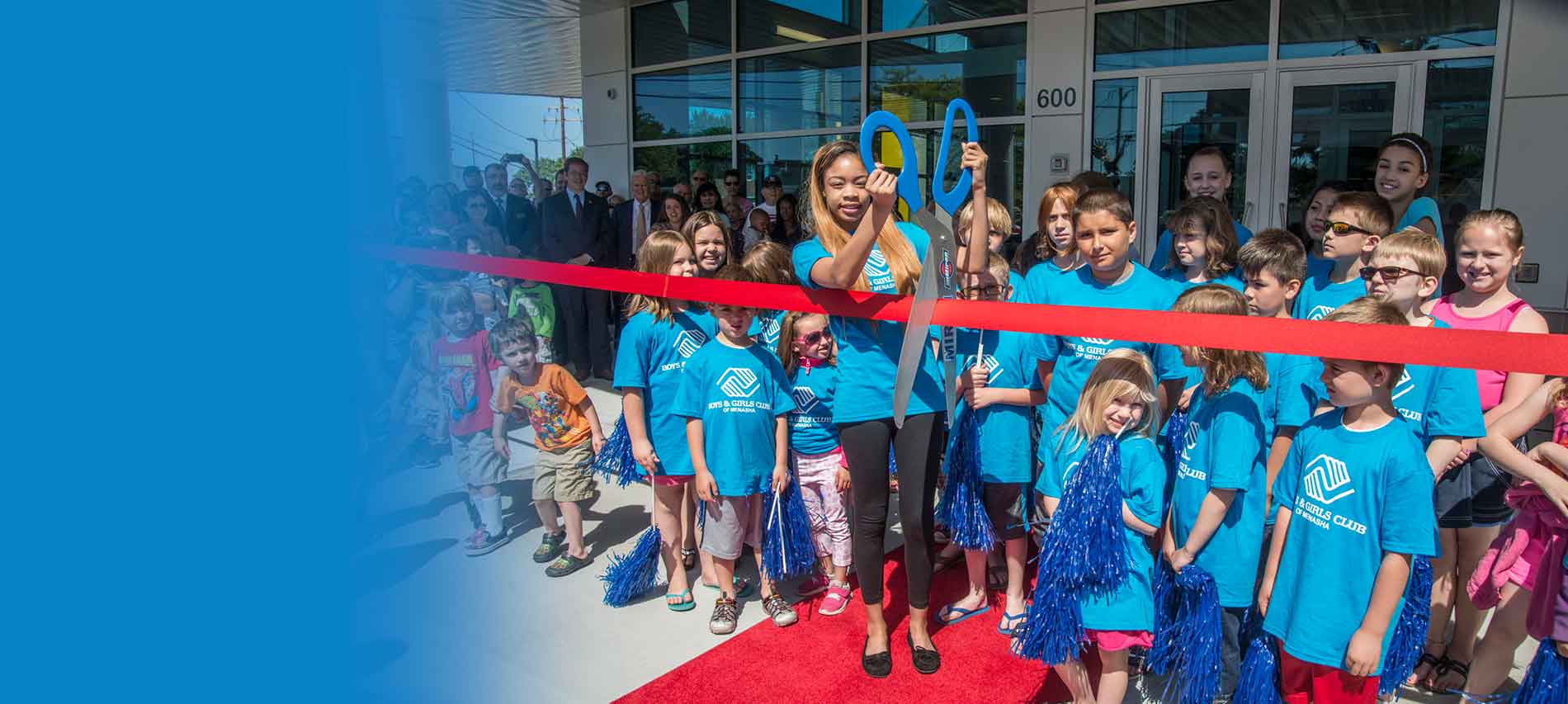 Ribbon cutting with group of kids at Boys and Girls Club of Menasha