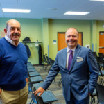 Two men smiling in meeting room