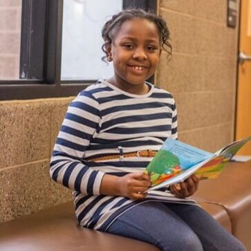 During National Reading Month, we're proud to showcase our Page Turners Early Literacy program! Page Turners helps young minds discover the joy of reading while improving their reading skills. 📖 #NationalReadingMonth 

Hear what some youth and tutors have to say about the program:
Abby loves the Pigeon books and Elephant and Piggie, which she reads with great expression! "I like reading and the games. I like the types of books here.” Abby (Page Turners participant)

“In only six weeks, I’ve seen kids growing in confidence as they practice basic reading skills. Students who would barely speak when I first met with them now get excited to participate.” Diane (Page Turners tutor)